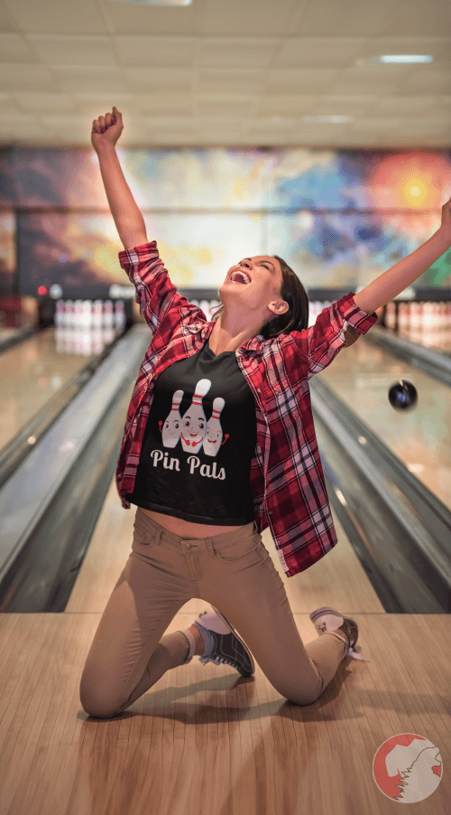 Joyful-woman-celebrating-victory-in-bowling-depicted-in-pin-pals-t-shirt