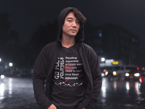 asian-man-wearing-a-reading-japanese-is-easy-shirt-while-on-the-street-at-night