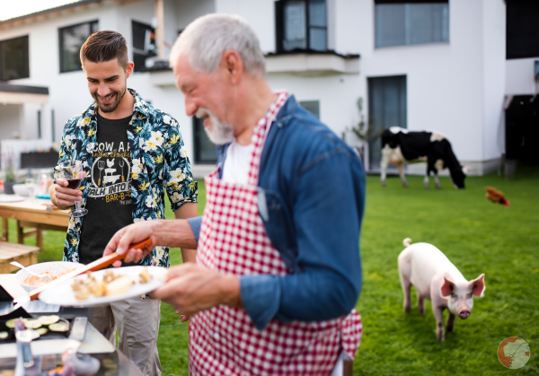 T-shirt-mockup-showcasing-a-man-at-a-barbecue-wearing-a-cow-a-pig-and-a-chicken-walk-into-a-bbq-shirt