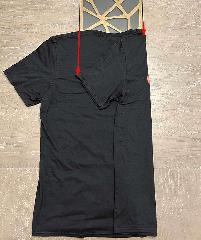 a black shirt indicating where to fold.