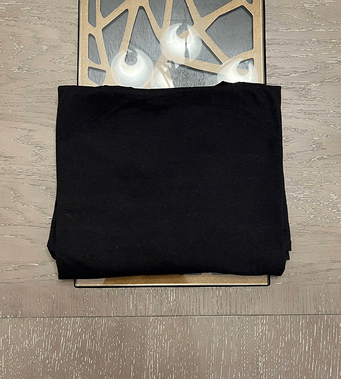 a black shirt indicating where to start folding.