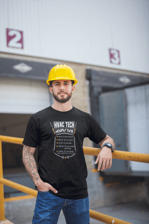 Tattooed man wearing a HVAC Tech Hourly Rate t-shirt outside the warehouse