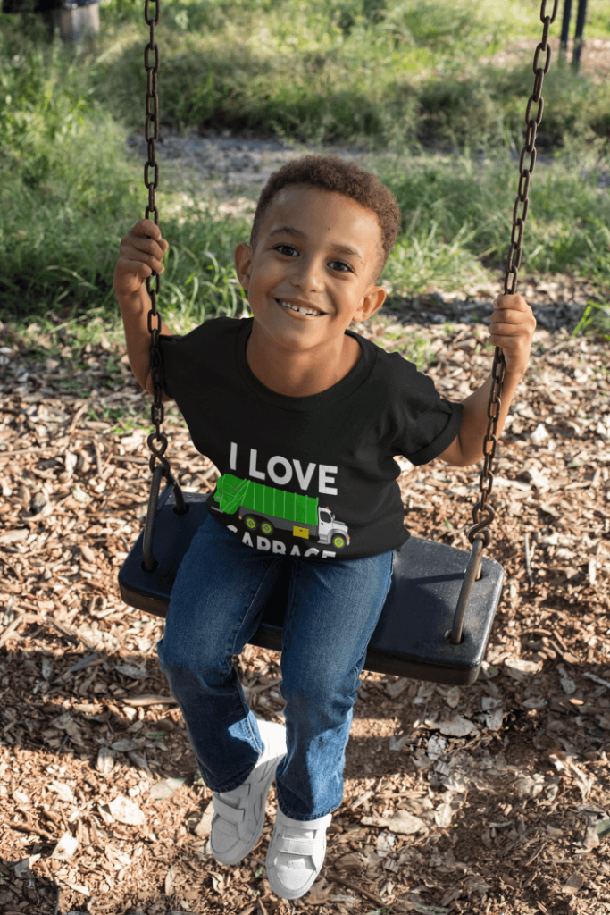 i-love-garbage-trucks-t-shirt-mockup-of-a-smiling-boy-playing-on-a-swing