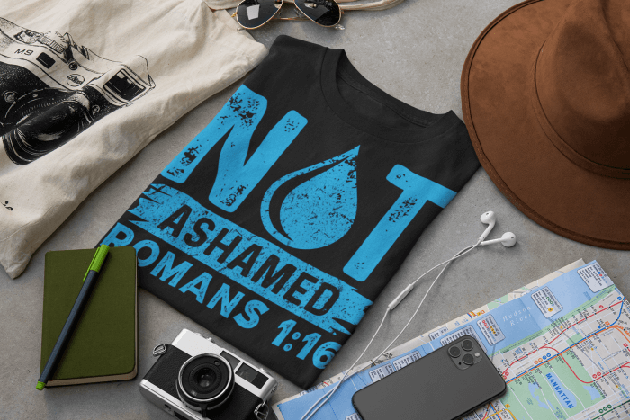 not-ashamed-t-shirt-mockup-surrounded-by-travel-accessories